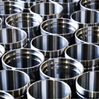 Machined downhole oil tool mandrel
